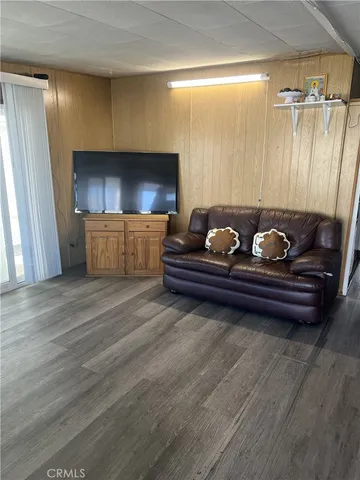 a room with wooden floor and furniture