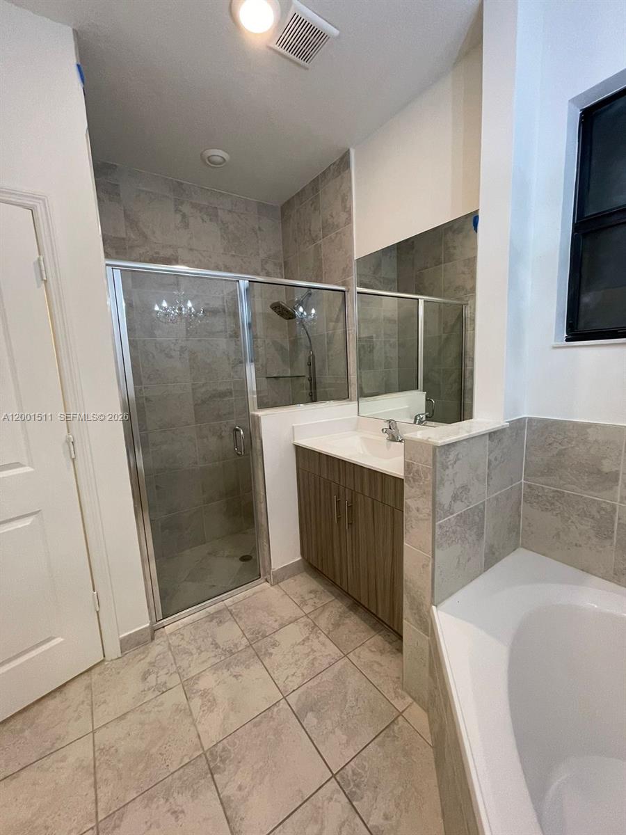 4451 Southwest 159th Path Miami, FL 33185 - Photo 13 of 24 a bathroom with a tub a sink and a shower