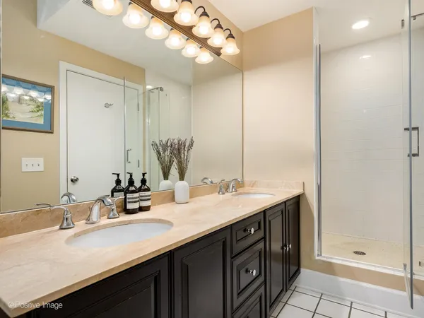 a bathroom with a sink double vanity and a mirror