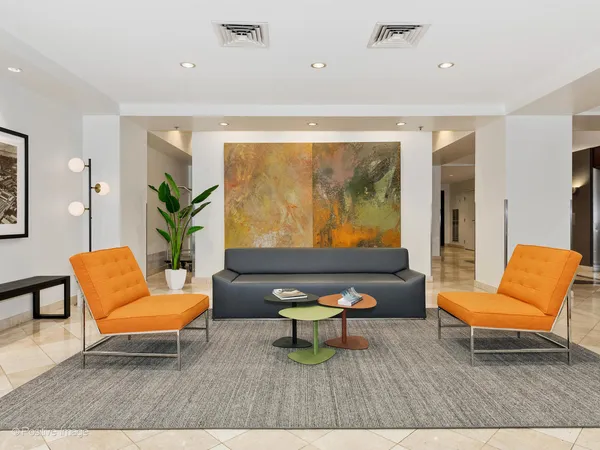 a living room with furniture and a potted plant