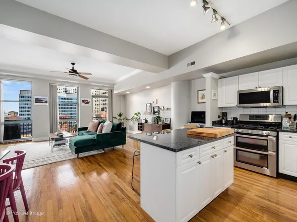a view of a living room kitchen and a wooden floor