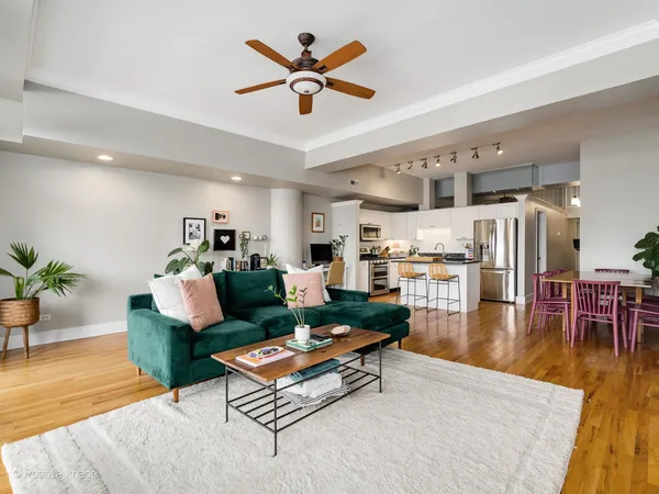a living room with furniture kitchen view and a table