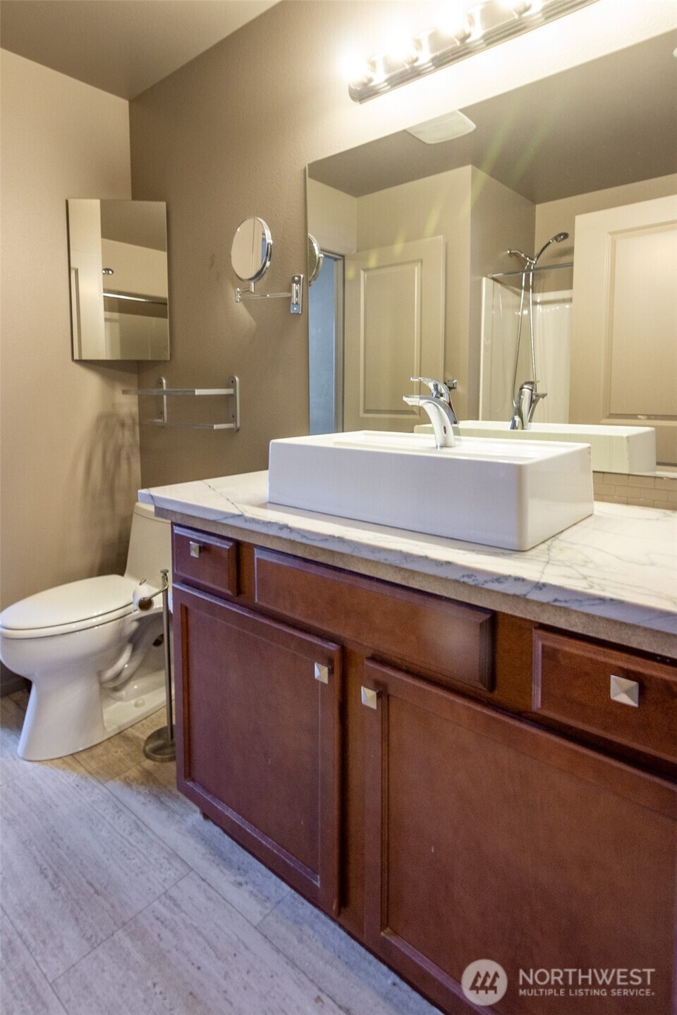 5686 Correll Drive, Unit 101 Ferndale, WA 98248 - Photo 16 of 22 a bathroom with a granite countertop sink a toilet and a mirror