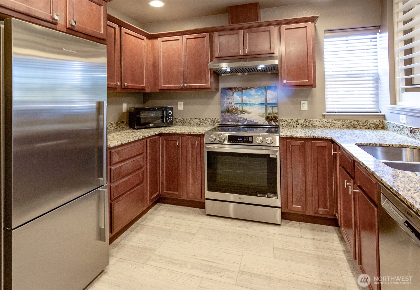 5686 Correll Drive, Unit 101 Ferndale, WA 98248 - Photo 3 of 22 a kitchen with stainless steel appliances granite countertop a stove a sink and a refrigerator