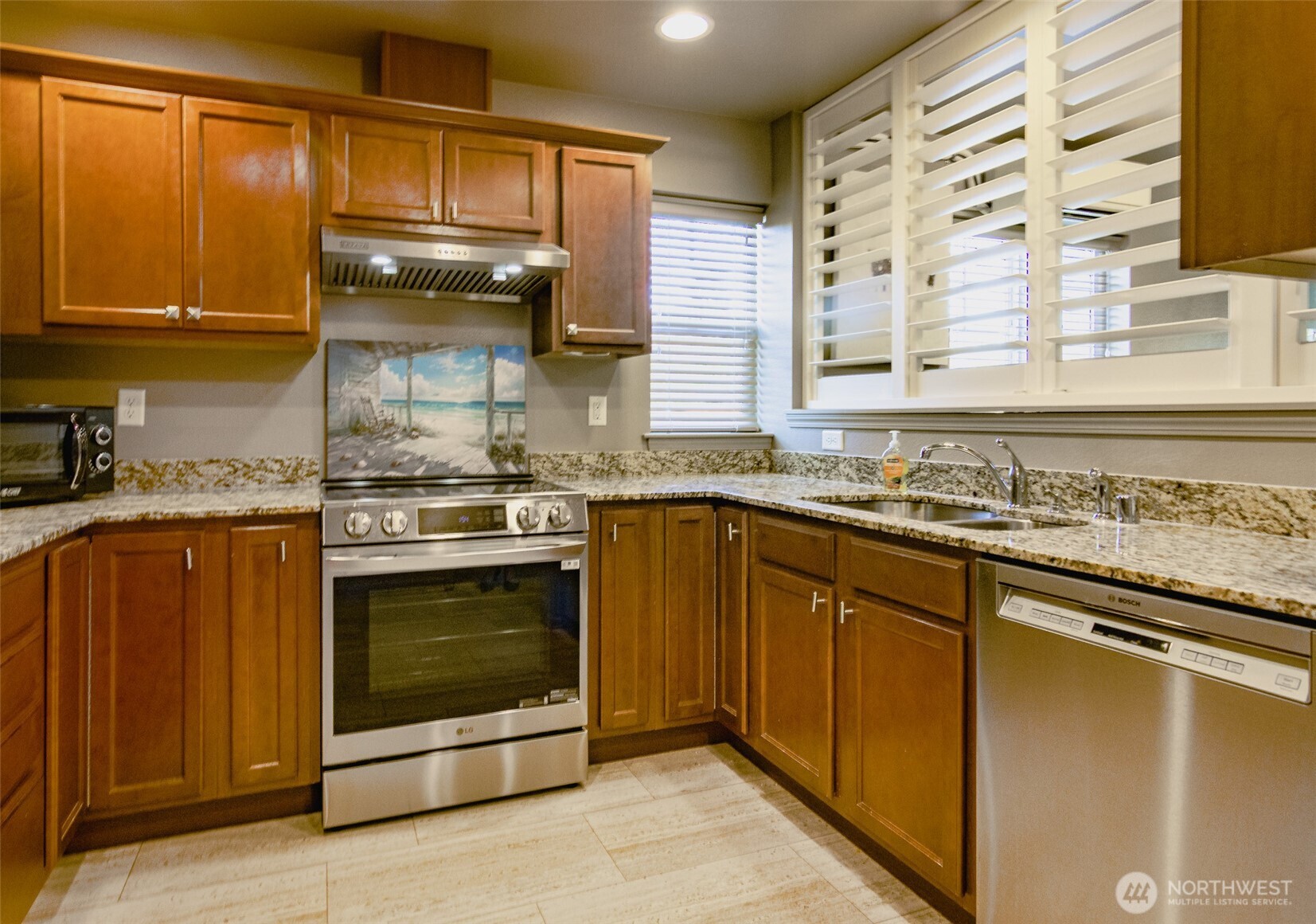 5686 Correll Drive, Unit 101 Ferndale, WA 98248 - Photo 4 of 22 a kitchen with stainless steel appliances granite countertop a stove and a sink