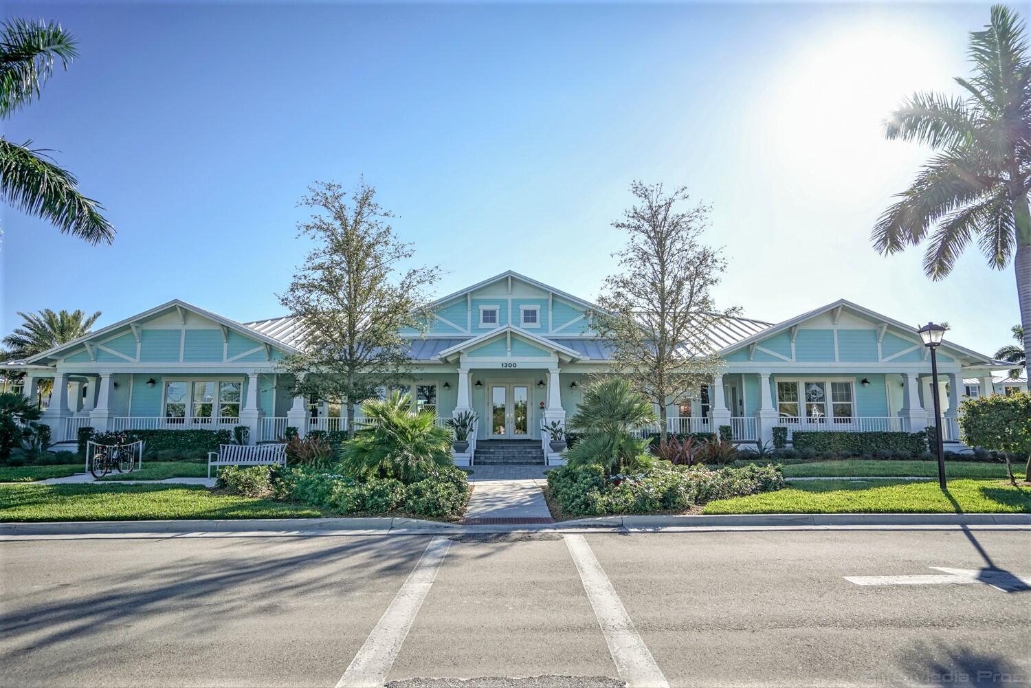 1132 South Community Drive Jupiter, FL 33458 - Photo 11 of 20 a front view of a house with a garden and plants