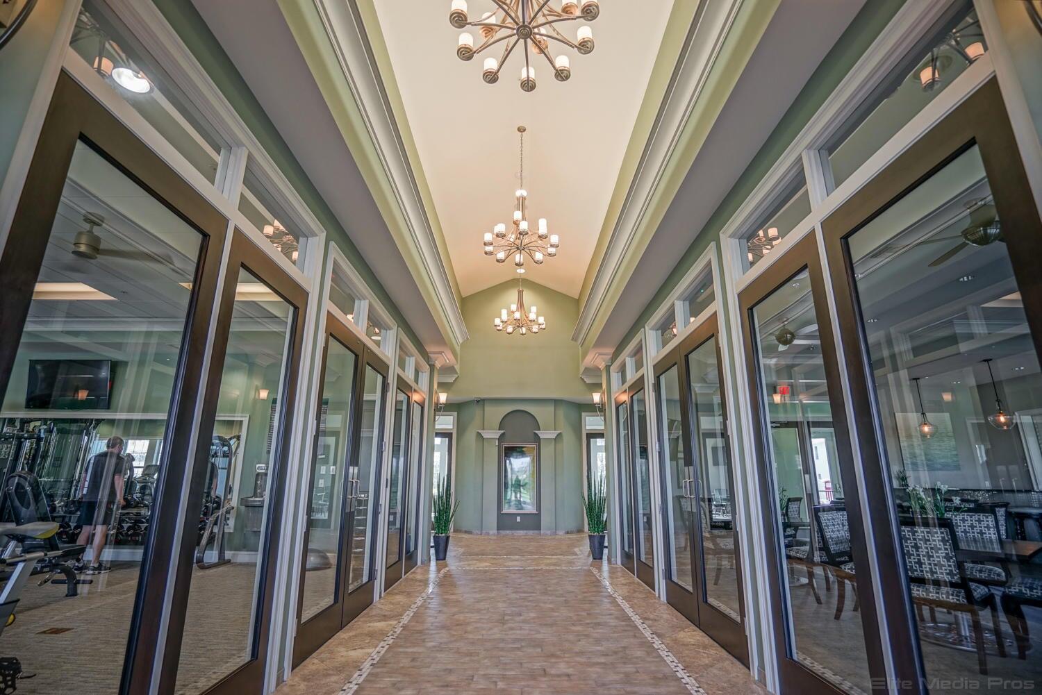 1132 South Community Drive Jupiter, FL 33458 - Photo 16 of 20 a view of a hallway with a chandelier