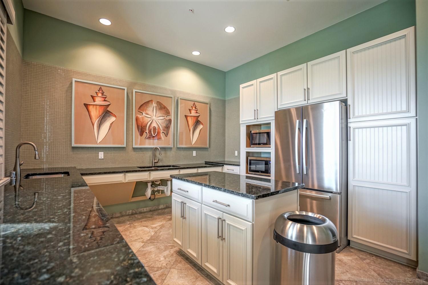 1132 South Community Drive Jupiter, FL 33458 - Photo 18 of 20 a kitchen with stainless steel appliances granite countertop a refrigerator a stove and a sink