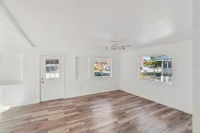 a view of room with window and wooden floor