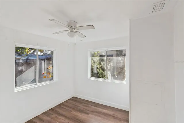 a view of room with window and ceiling fan