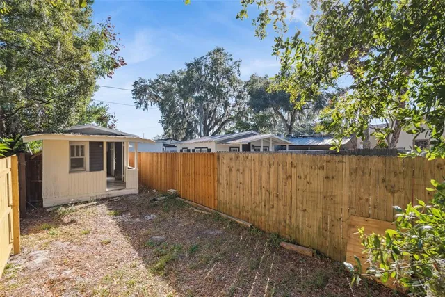 a backyard of a house with a tree