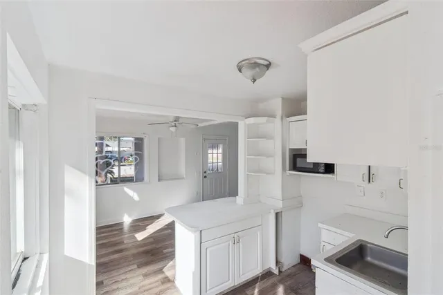 a kitchen with a refrigerator and a stove top oven