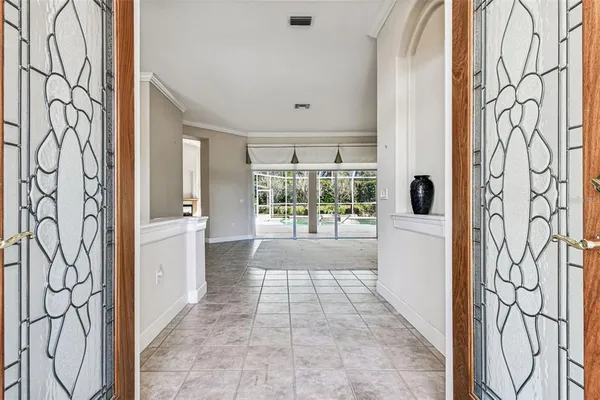 a view of a livingroom with a chandelier furniture and windows