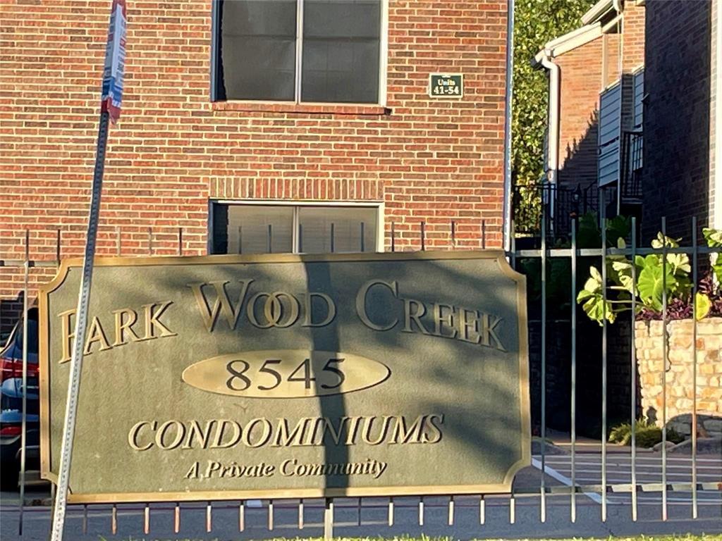 8545 Midpark Road, Unit 11 Dallas, TX 75240 - Photo 14 of 19 a sign that is on the wall of building