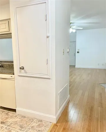a view of a room with wooden floor and a window