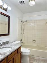 8545 Midpark Road, Unit 11 Dallas, TX 75240 - Photo 10 of 19 a bathroom with a granite countertop sink a toilet and bathtub