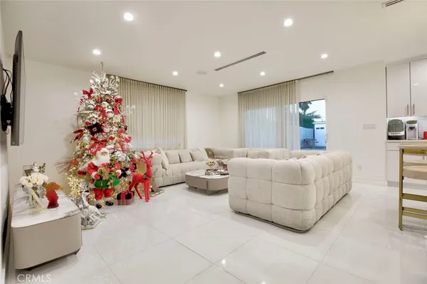 a living room with furniture and flowers