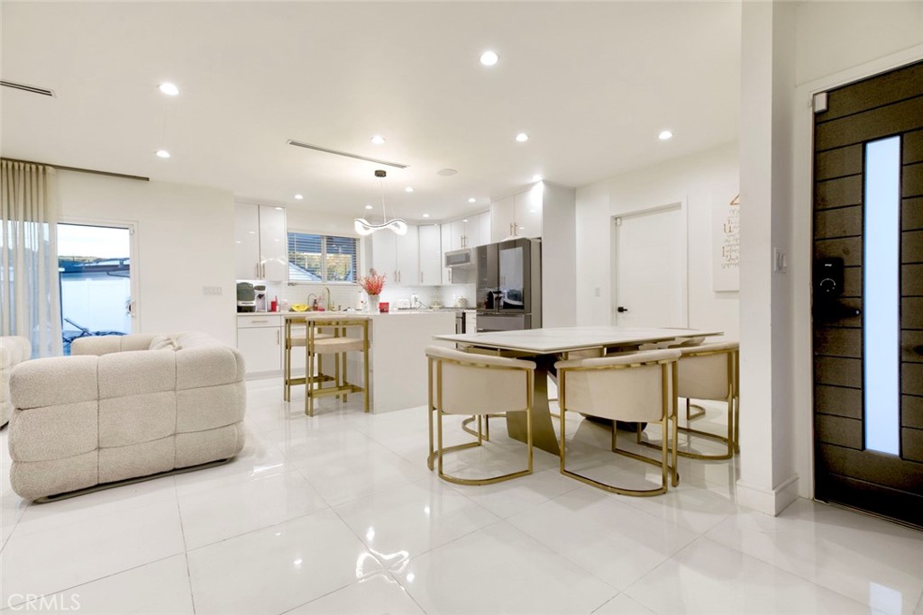 10263 Strathern Street Sun Valley, CA 91352 - Photo 4 of 19 a living room with furniture and a dining table with kitchen view
