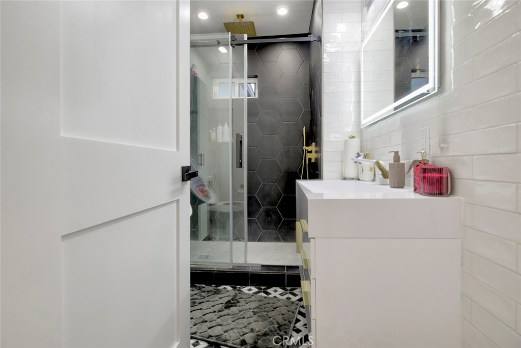 10263 Strathern Street Sun Valley, CA 91352 - Photo 8 of 19 a bathroom with a shower and a sink