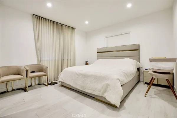 a bedroom with bed and a couch