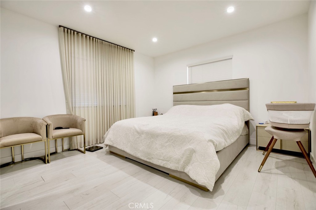 10263 Strathern Street Sun Valley, CA 91352 - Photo 9 of 19 a bedroom with bed and a couch