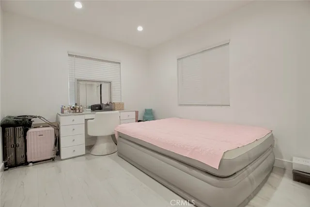 a bedroom with a white bed and white walls