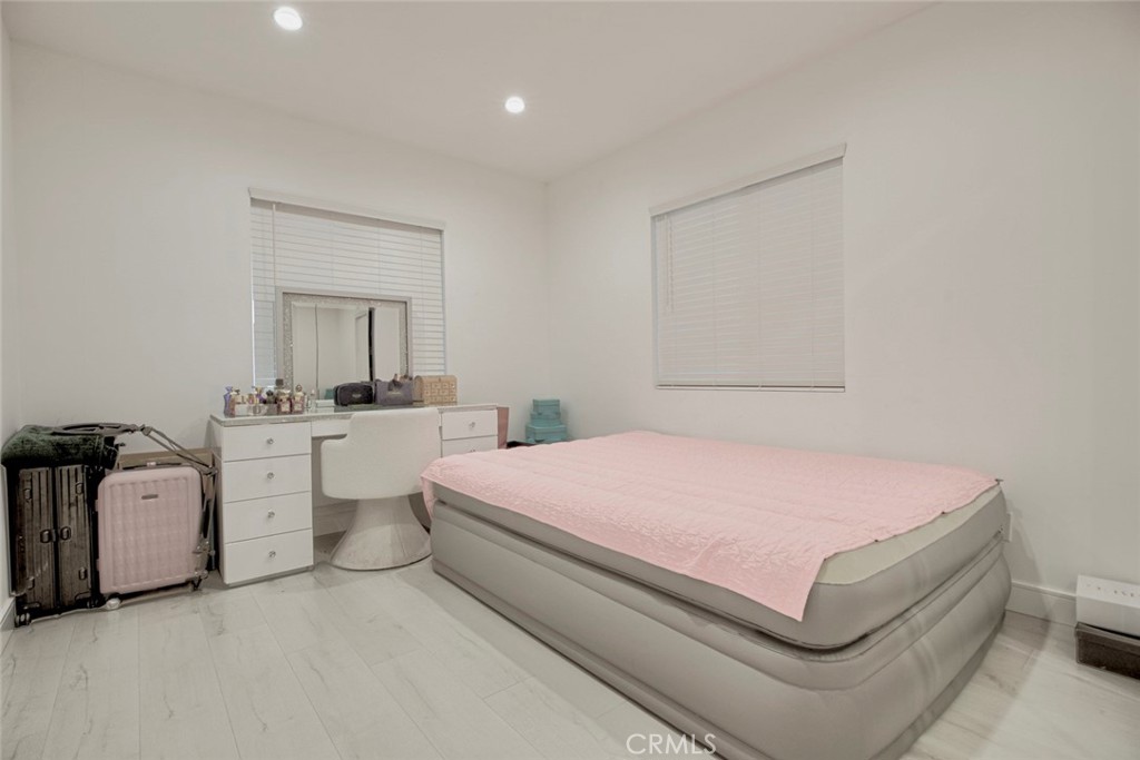 10263 Strathern Street Sun Valley, CA 91352 - Photo 10 of 19 a bedroom with a white bed and white walls