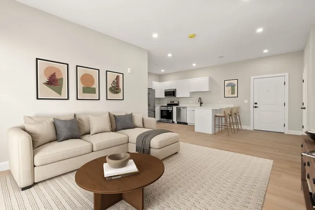 a living room with furniture and kitchen view