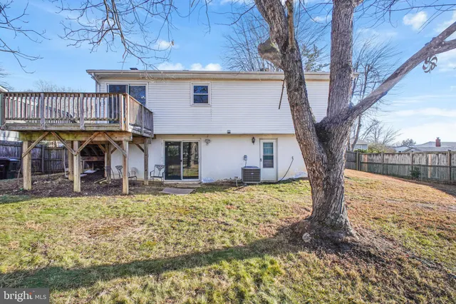 a view of a house with a yard covered in snow