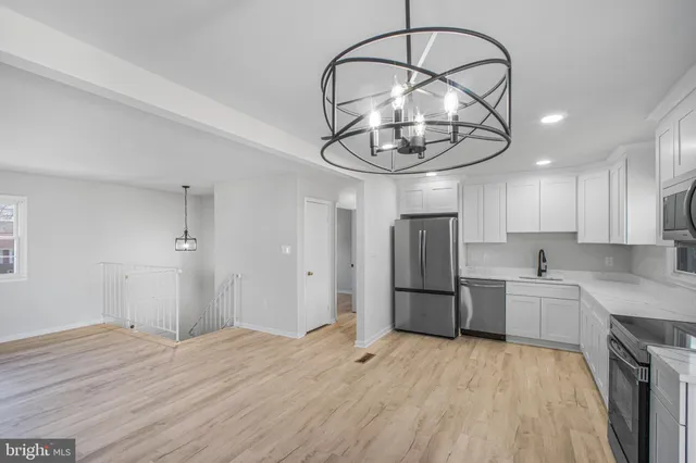 a kitchen with stainless steel appliances granite countertop a refrigerator and microwave