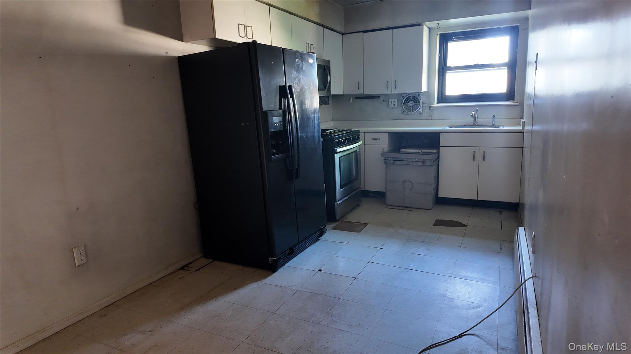 80 Sneden Place, Unit 80 Spring Valley, NY 10977 - Photo 5 of 5 a kitchen with refrigerator and window