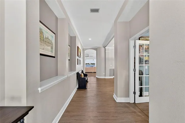 an aerial view of a house with a outdoor space and lake view in back
