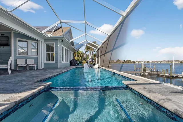 a kitchen with white cabinets and black appliances