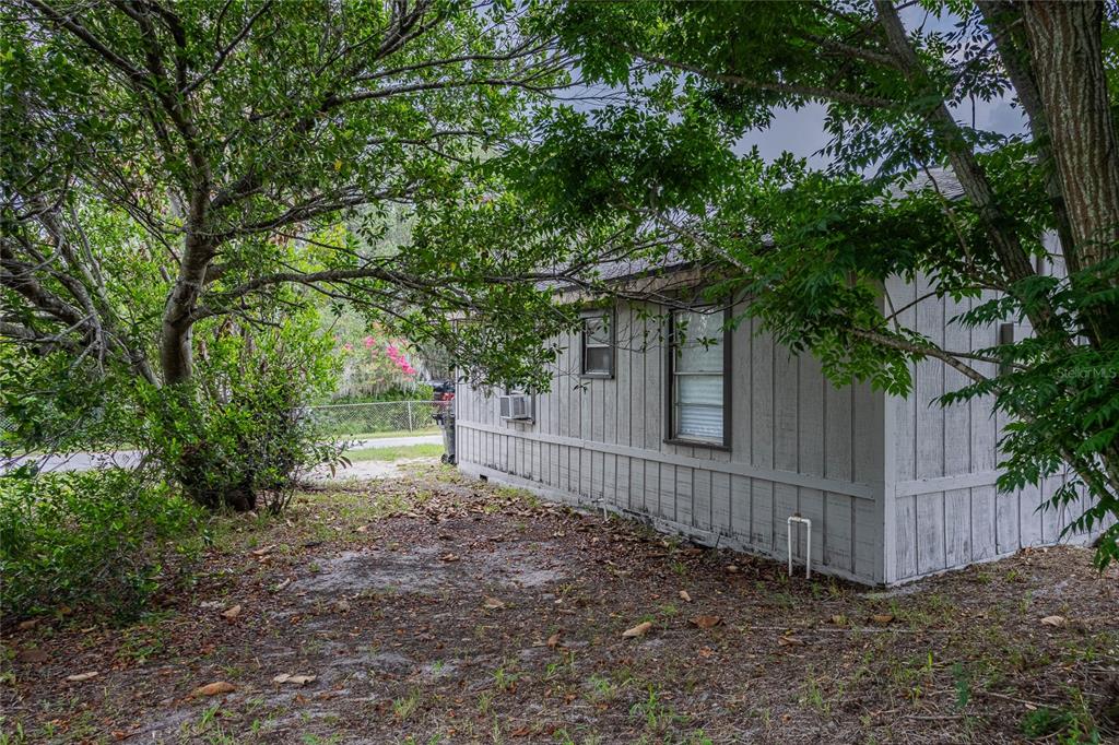 5 North Street Frostproof, FL 33843 - Photo 7 of 22 a view of a yard with wooden fence and a large tree