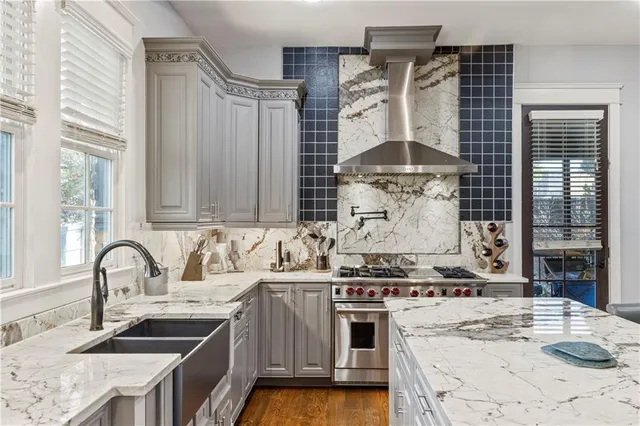 a stove top oven sitting inside of a kitchen