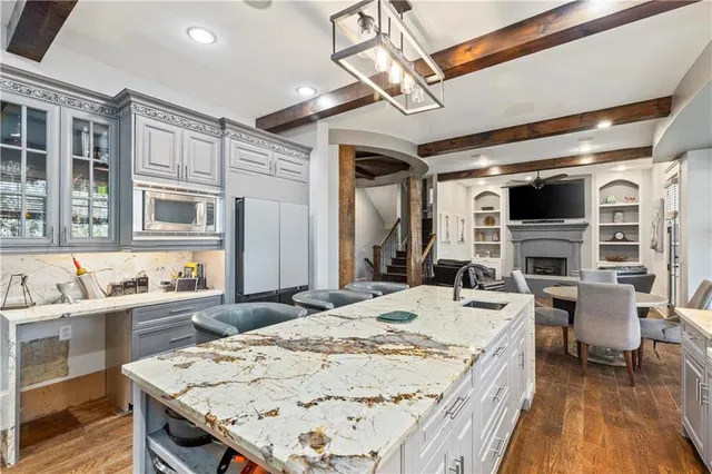 a living room with furniture ceiling fan and a rug
