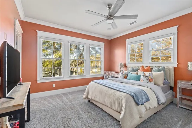 a bed sitting in a bedroom next to a window