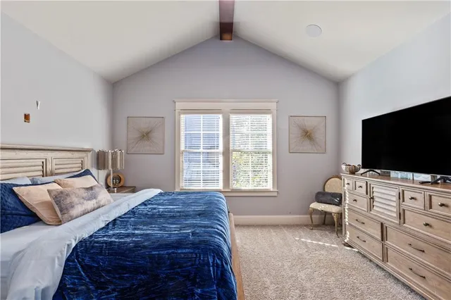 a spacious bedroom with a bed and glass door