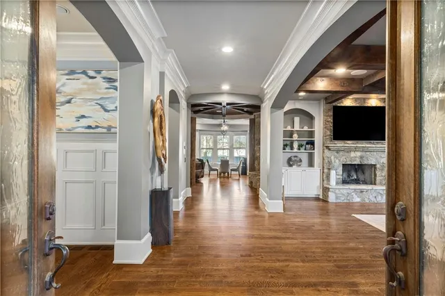 a living room with furniture a fireplace and a flat screen tv