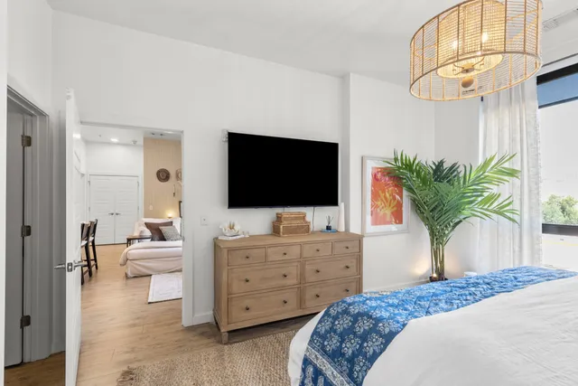 a bedroom with a bed and a flat screen tv