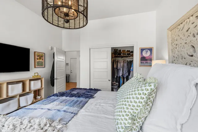 a bedroom with a bed and a flat screen tv