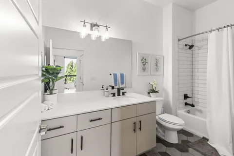 a bathroom with a toilet a sink and mirror