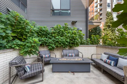 a backyard of a house with outdoor seating