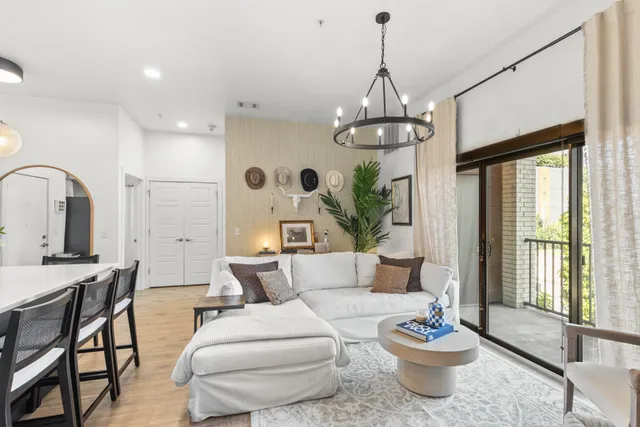 a living room with furniture a window and dining table
