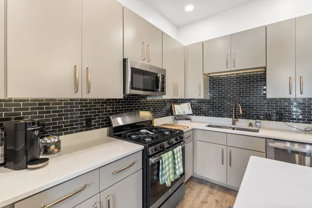 a kitchen with a sink stove and cabinets