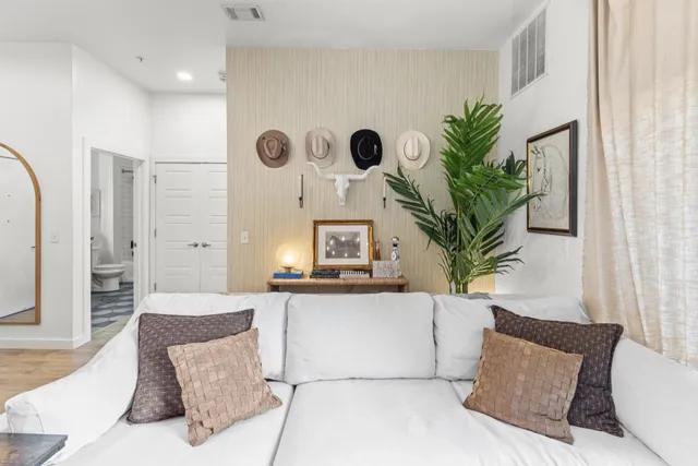 a living room with furniture and a large mirror