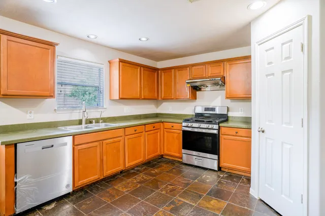 a view of a kitchen with a sink and cabinets