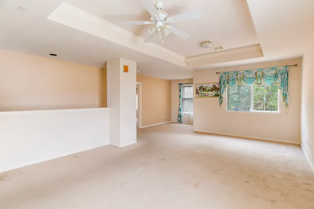 an empty room with windows and closet