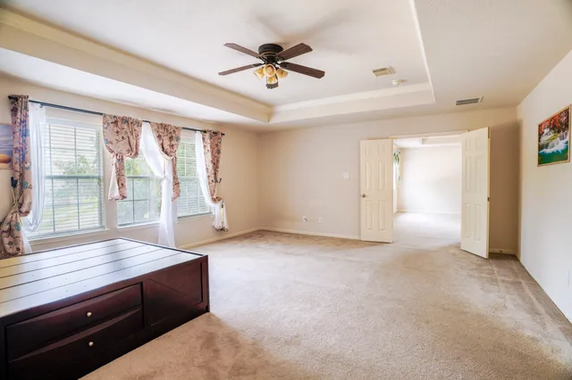 a view of room with furniture ceiling fan and window