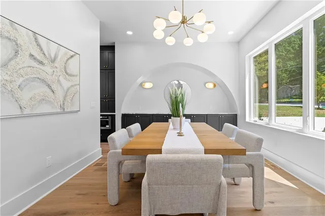 a kitchen with stainless steel appliances granite countertop a sink counter space cabinets and a refrigerator